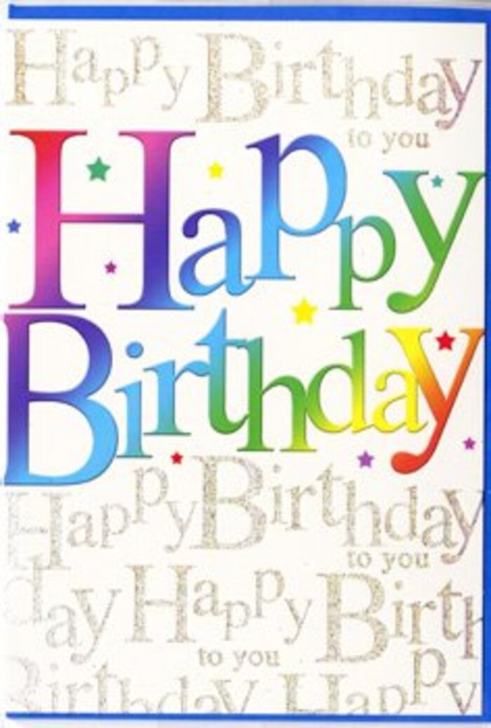 The image shows a joyful birthday card that seems to radiate colour, the kind of design you might find propped beside a vibrant bouquet in a Mile End flower shop window. Across the centre, the phrase Happy Birthday stretches in substantial, rounded letters, each one filled with a smooth gradient wash of colour. The tones travel like a gentle arc from rich crimson and candy pink through shades of violet, cobalt, aqua, and leafy green, before settling into warm amber and golden yellow at the far end. This rainbow effect makes the words feel almost like they are glowing, reminiscent of the bright bunting you might see at a family celebration near Mile End Park on a sunny afternoon. Behind the main greeting, the background is completely overlaid with small, repeating cursive text, written in a soft metallic gold that looks like it has been laid down in fine, looping strokes. The script quietly repeats Happy Birthday to you, forming a delicate pattern that shimmers just enough to catch the eye when the surface tilts toward the light. There are scattered tiny dots and star-like accents in coordinating colours, giving the impression of light confetti gently sprinkled across the design, while still leaving plenty of white or pale space so the card never feels crowded. The cardstock appears smooth to the touch, with a slightly glossy or satin finish that enhances the luminosity of both colours and gold script. Overall, the card conveys an upbeat, affectionate mood-perfect to accompany a hand-delivered arrangement sent to a friend along Burdett Road or around the streets leading to Roman Road Market for a birthday full of happy wishes.